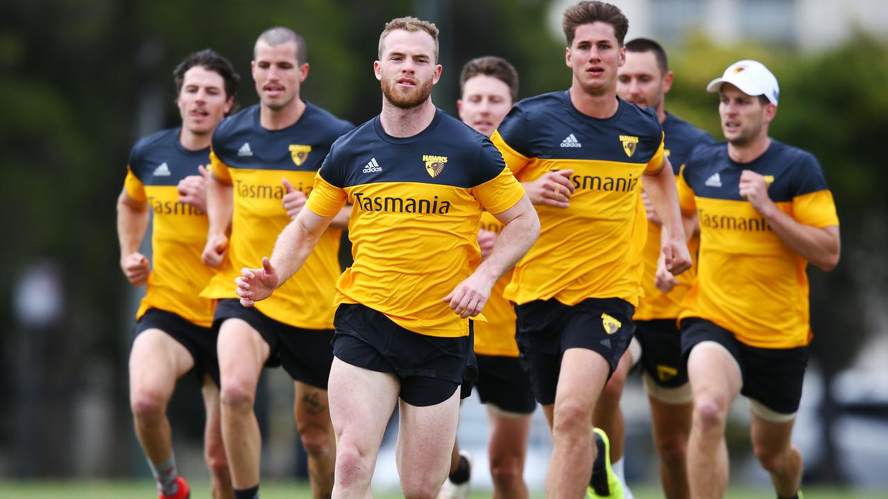 Tom Mitchell of the Hawks leads a running session at Xavier College on Monday.