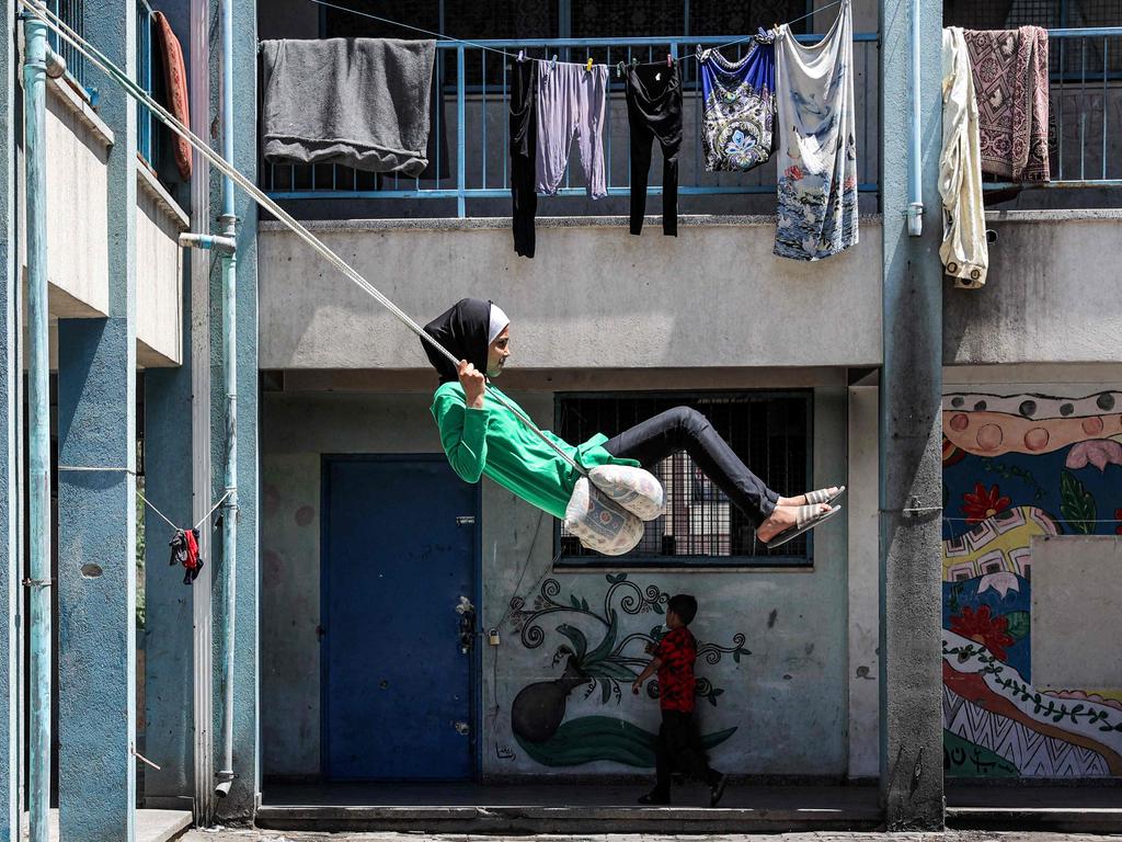 A girl rides a makeshift swing in the yard of a school run by the United Nations at the Shati camp for Palestinian refugees, west of Gaza City. Picture: AFP