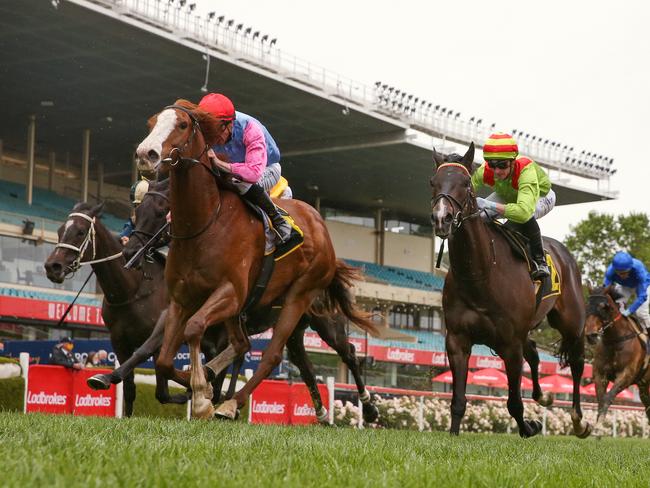 MELBOURNE. 23/10/2021. Moonee Valley Races. Race 6. . The Schweppes Crystal Mile.   Just Folk ridden John Allen (red cap) beats Begood Toya Mother ridden by Daniel Moor (striped cap) in race 6    . Photo by Michael Klein