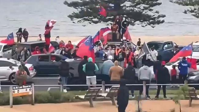 A teenage girl is in a serious condition after falling from car in Altona while celebrating Samoa's Rugby League World Cup, A man is seen on the roof of a car Picture: Supplied