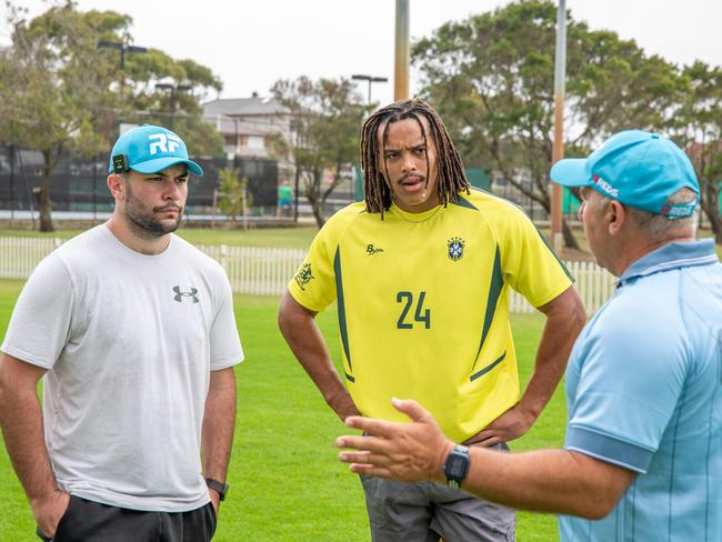 (L to R): Tyson Jackson, Dominic Young listen to Roger Fabri during a training session. Picture Thomas Lisson