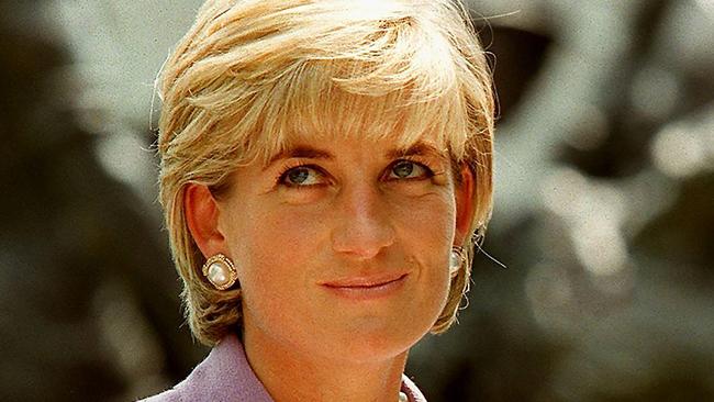 Princess Diana mourners have gathered at the gates of Kensington Palace to mark the 20th anniversary since her death. Picture: JAMAL A. WILSON/AFP