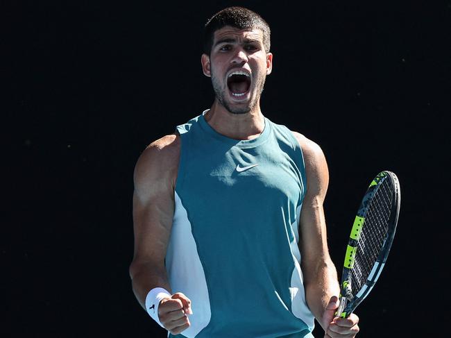 TOPSHOT - Spain's Carlos Alcaraz celebrates the match point and victory against Portugalâs Nuno Borges in their men's singles match on day six of the Australian Open tennis tournament in Melbourne on January 17, 2025. (Photo by Martin KEEP / AFP) / -- IMAGE RESTRICTED TO EDITORIAL USE - STRICTLY NO COMMERCIAL USE --