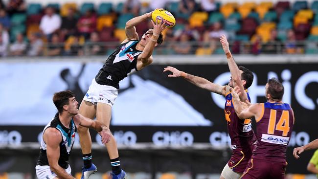 Connor Rozee takes a screamer against Brisbane at the Gabba on Saturday night. Picture: DAVE HUNT (AAP).