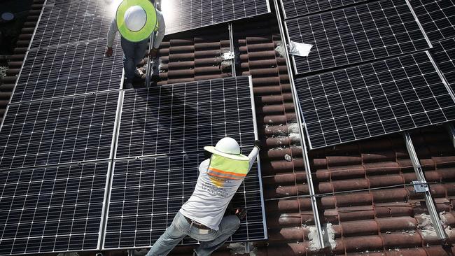 Solar panels are installed on a roof. The SA Government has announced a solar panel scheme for 50,000 SA homes, which will link up to create a virtual power plant. Picture: AFP