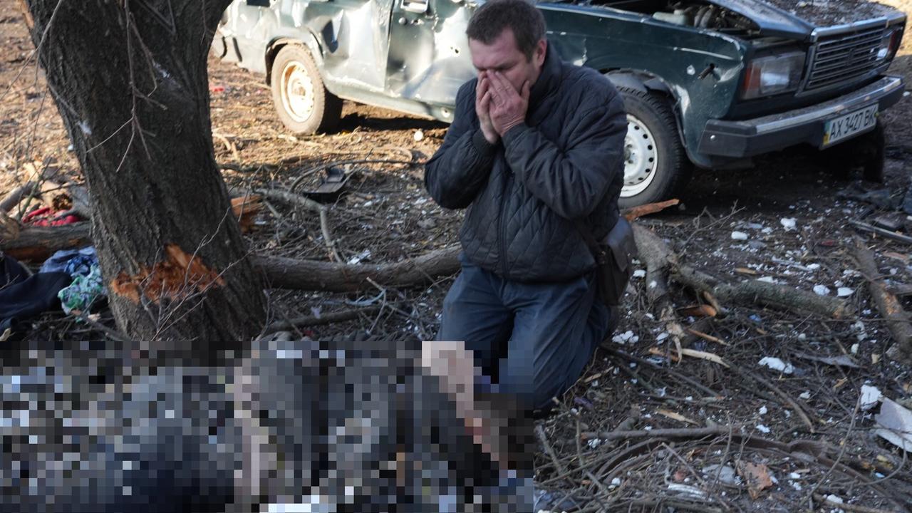 A man can be seen crying over a loved one’s body. Picture: Wolfgang Schwan/Anadolu Agency via Getty Images