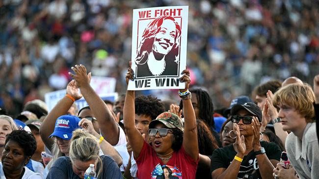 Democratic supporters cheer Ms Harris and Mr Obama. Picture: AFP