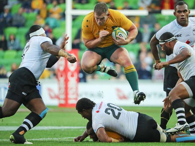 Toby Smith leaps over a Fijian player.