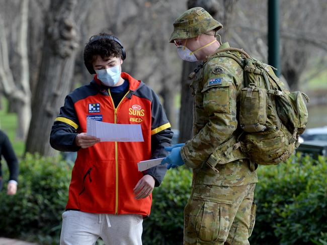 ADF personnel patrol South Yarra looking for people not wearing masks. Picture: Andrew Henshaw