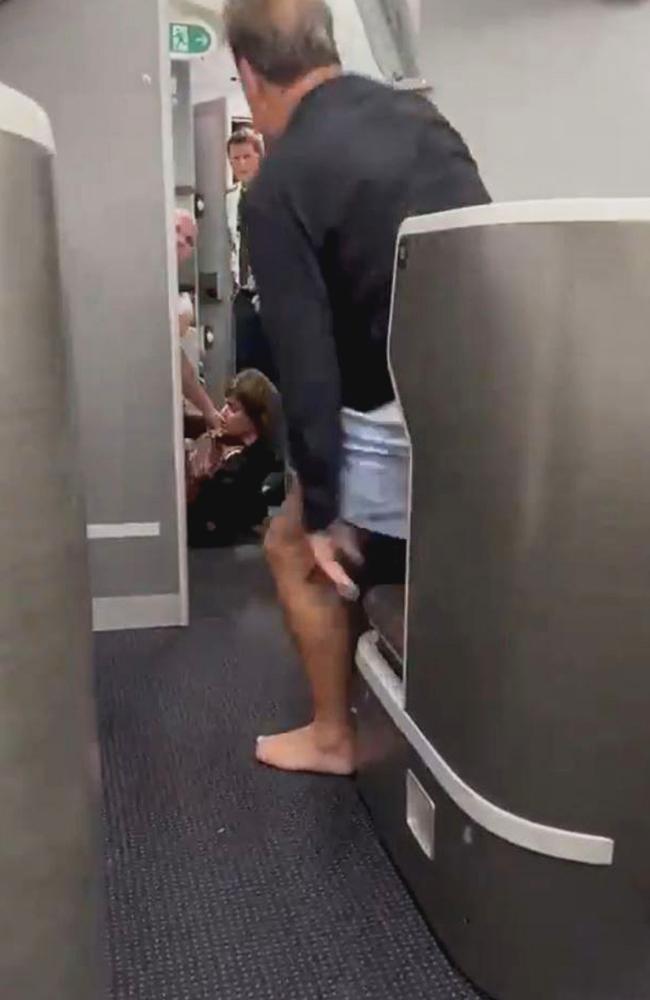 The woman was seen on the ground as fellow passengers were left shocked by the brawl. Picture: Newsflash/NX
