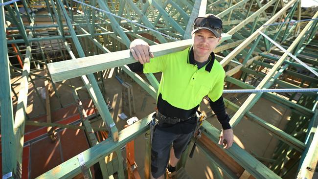 Leading hand Aaron Stewart at work on the roof of a JR Construction home in Tarragindi, Brisbane, where tradies are in very short supply. Picture: Lyndon Mechielsen