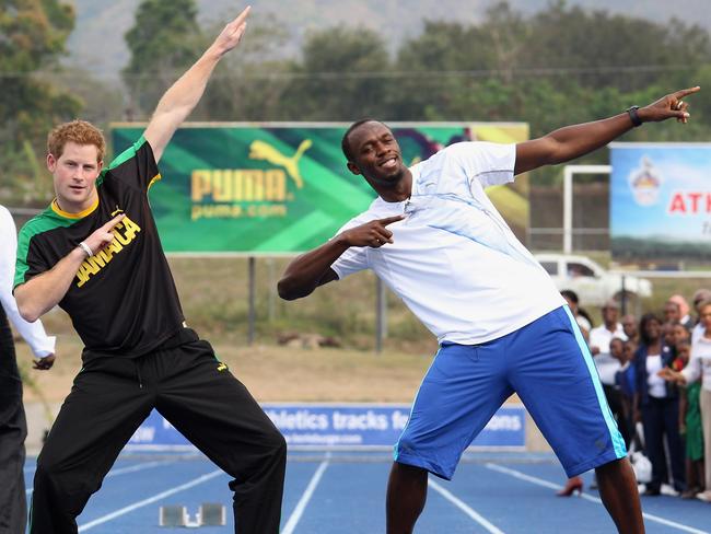 Prince Harry poses with Usain Bolt after racing against him at the Usain Bolt Track at the University of the West Indies on March 6, 2012 in Kingston, Jamaica. Picture: Getty