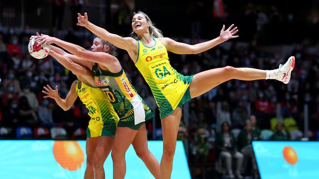 Paige Hadley and Gretel Bueta of Australia and Zanele Vimbela of South Africa reach for the ball of the 2022 Netball Quad Series match between Australia and South Africa at Copper Box Arena. Photo: Getty Images