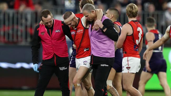 An injured David Zaharakis is assisted from the field. Picture: AAP