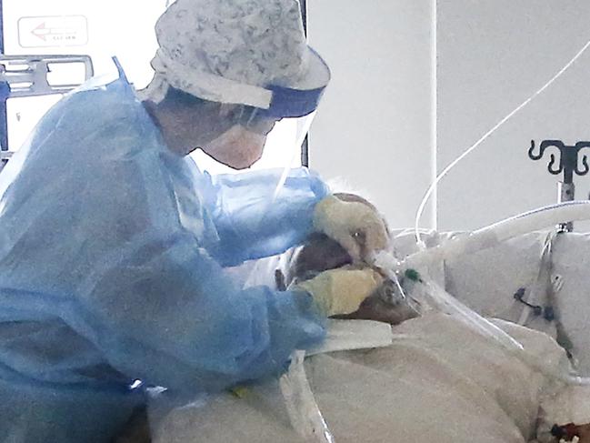 Behind the Scenes at the Royal Melbourne Hospital ICU. ICU nurse Chelsea Wong caring for a COVID patient in the ICU COVID ward.   Picture: David Caird