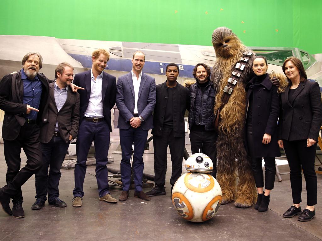 US actor Mark Hamill, US director Rian Johnson, Britain’s Prince Harry, Britain’s Prince William, British actor John Boyega, character Chewbacca and British actress Daisy Ridley, from left, and droid BB-8 pose for a photo during a tour of the Star Wars sets at Pinewood studios in Iver Heath, west London, Tuesday April 19, 2016. Picture: AP