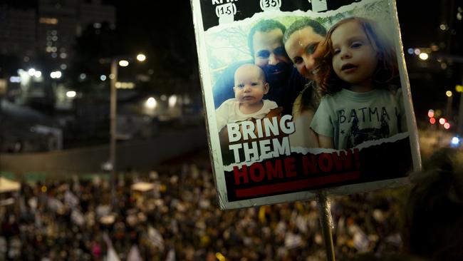 A sign with photos of the Bibas family, held hostage in the Gaza Strip, during a rally in Israel in December. Picture: Getty