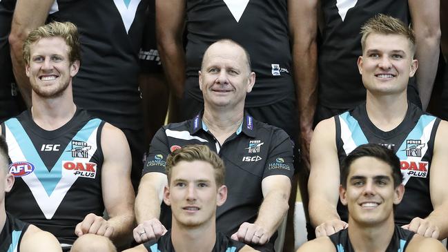 Coach Ken Hinkley sits between his co-captains Tom Jonas and Ollie Wines on team photo day. Picture: SARAH REED