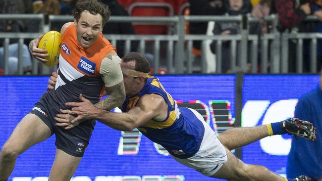 Shannon Hurn of the Eagles tackles Nathan Wilson of the Giants.