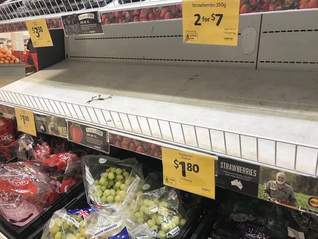 Empty shelves, normally stocked with strawberry punnets, are seen at a Coles Supermarket in Brisbane, Friday, September 14, 2018. Picture: AAP Image/Dan Peled