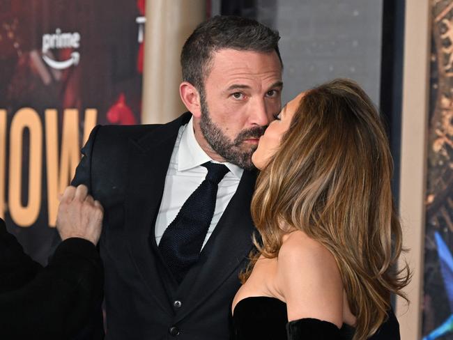 TOPSHOT - US actress Jennifer Lopez (R) and US actor Ben Affleck kiss as they attend Amazon's "This is Me... Now: A Love Story" premiere at the Dolby theatre in Hollywood, California, February 13, 2024. (Photo by Robyn BECK / AFP)