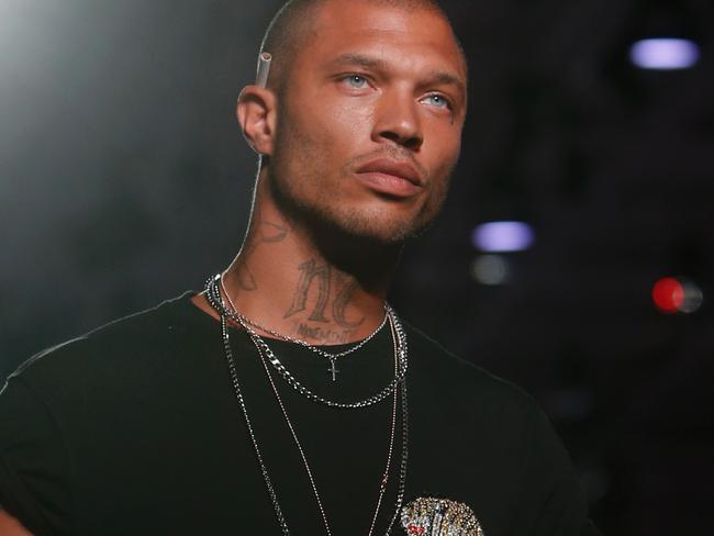 Model Jeremy Meeks presents a creation for fashion house Philippe Plein during the Men's Spring/Summer 2018 fashion shows in Milan, on June 17, 2017. / AFP PHOTO / Marco BERTORELLO