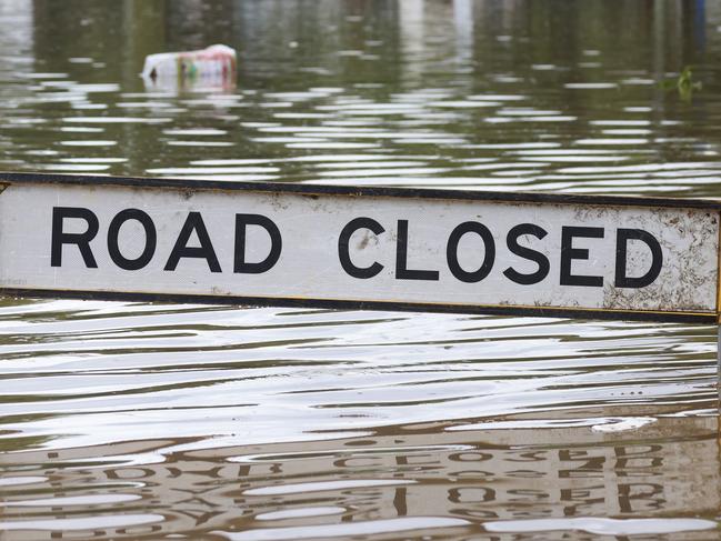 BRISBANE, AUSTRALIA - MARCH 03: A road closed sign in a flooded Vincent Street, Auchenflower on March 03, 2022 in Brisbane, Australia. From Brisbane in Queensland to Lismore in northern New South Wales, flood-affected communities are cleaning up debris as the weather system moves south towards Sydney. (Photo by Peter Wallis/Getty Images)