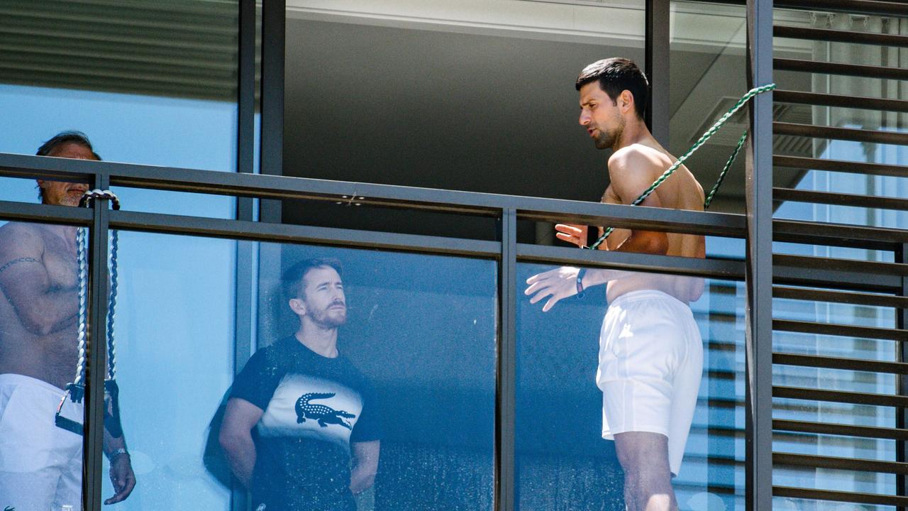 Men's world number one tennis player Novak Djokovic of Serbia exercises on a balcony