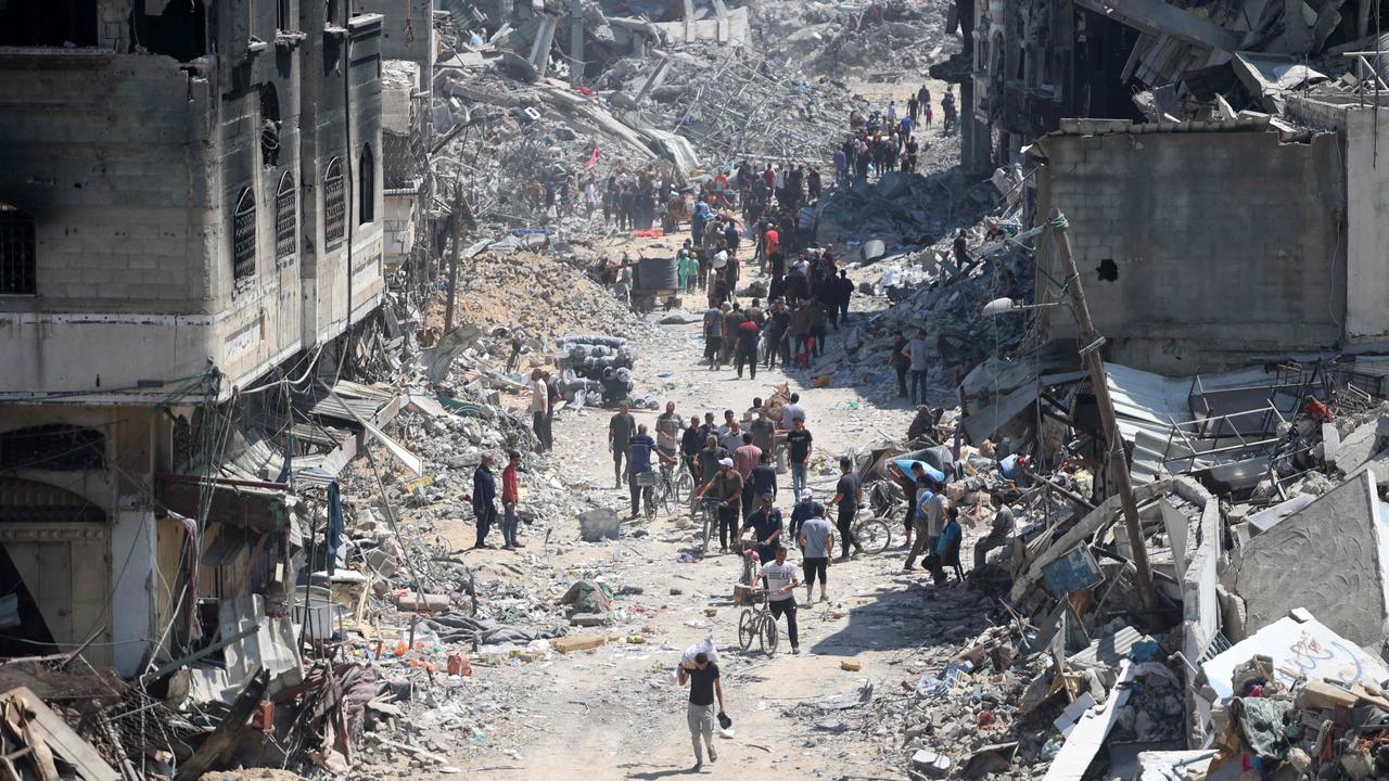 Palestinians carry some salvaged belongings as they leave the Jabalia refugee camp in the northern Gaza Strip after they returned briefly to check on their homes on May 31. Picture: Omar AL-Qattaa / AFP