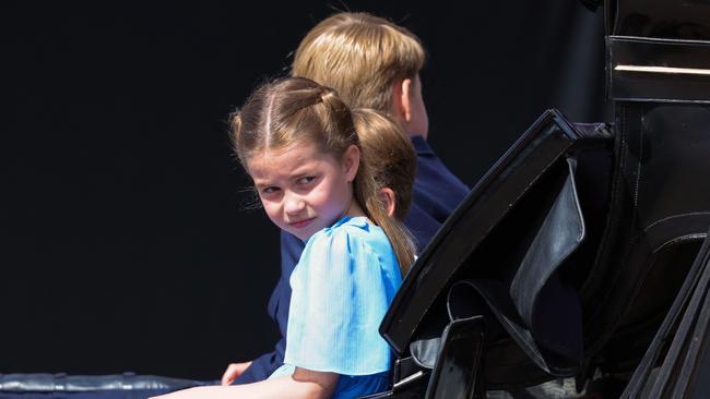 Princess Charlotte and her brothers arrived in a horse-drawn carriage. Picture: AFP