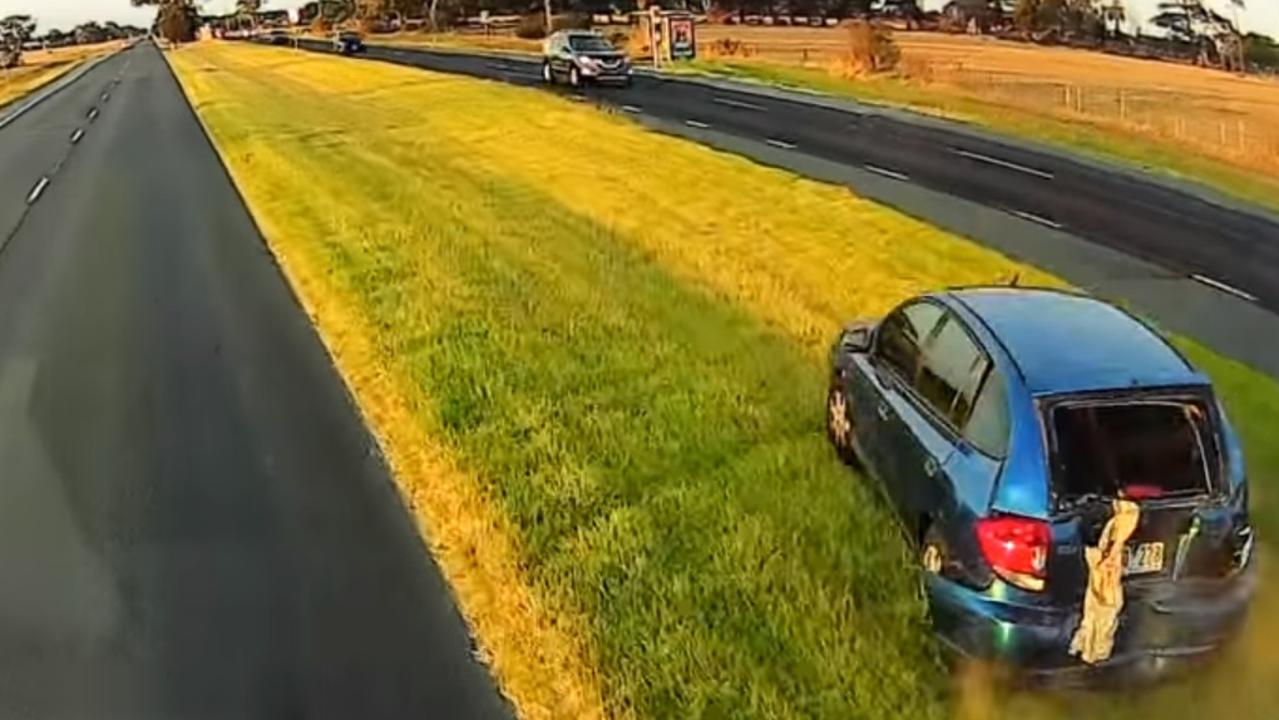 The blue hatchback gets pushed off the road. Picture: Dash Cam Owners Australia/ Facebook.