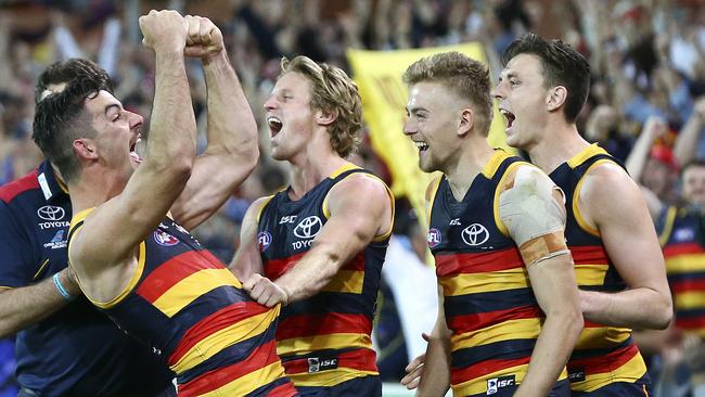 Adelaide skipper, Rory Sloane, Hugh Greenwood and Jake Lever in happier days after winning the 2017 preliminary final against Geelong. Picture Sarah Reed.