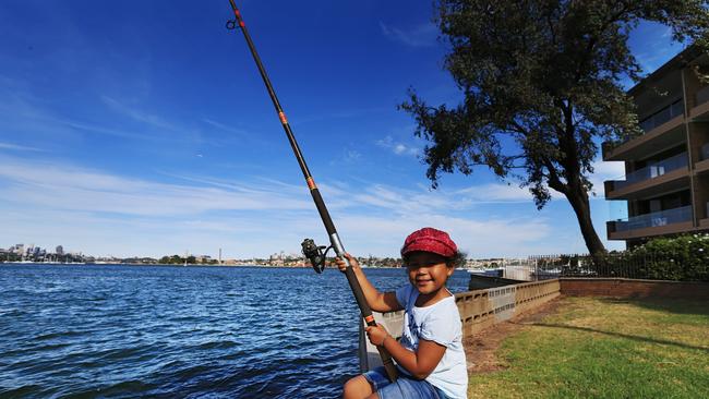 Jade Scott-Rogers 5 throws a fishing line into the area where the proposed sewerage pipe will come out at Drummoyne. Picture: Toby Zerna
