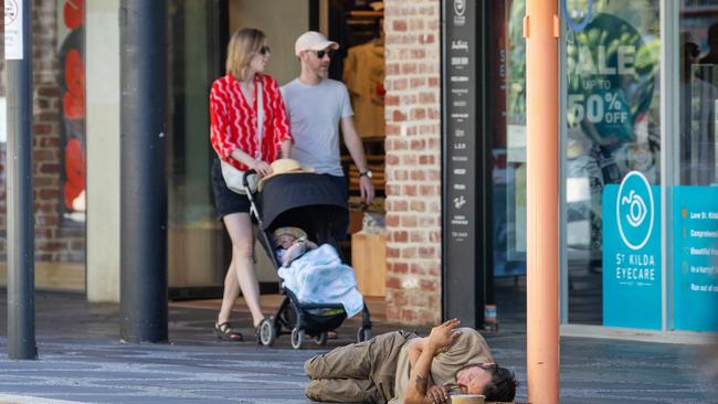 MELBOURNE, JANUARY 10, 2024: A man sleeps on the ground in Acland Street, St Kilda. Picture: Mark Stewart