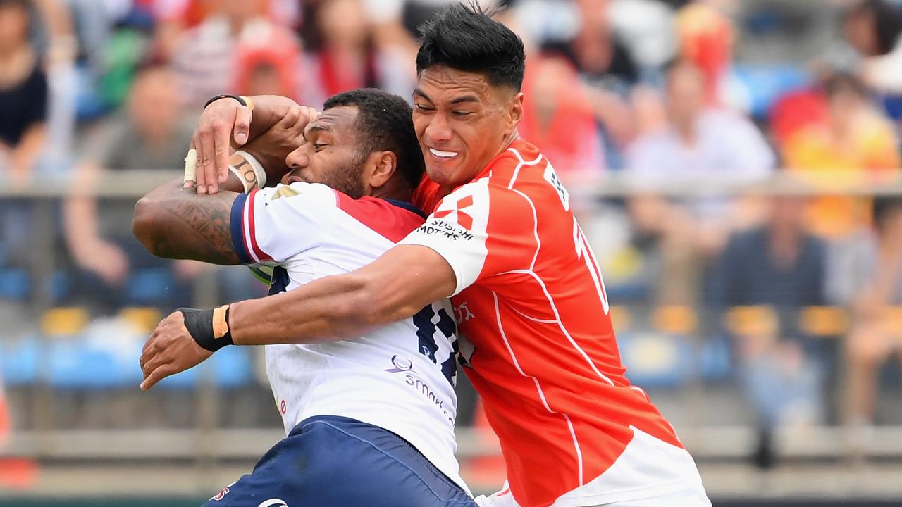 Queensland’s Samu Kerevi of the Reds is tackled by Timothy Lafaele of the Sunwolves on Saturday.