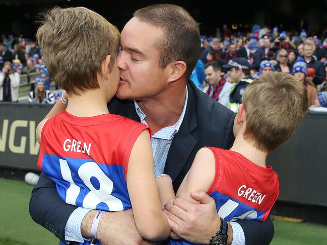 Brad Green kisses his son Wilba and hugs Oliver. Pic: Michael Klein