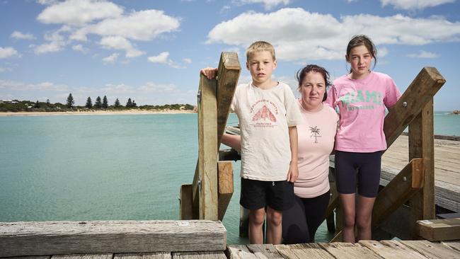 Locals Riley Gray, 8, with his mum, Tara Gray and sister, Ariana Gray, 12, in Port Elliot, where the Horseshow Bay pontoon was removed. Picture: Matt Loxton