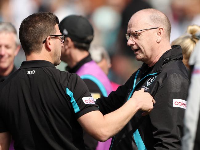 ADELAIDE, AUSTRALIA - AUGUST 27: Josh Carr, Midfield Coach of the Power talks to Ken Hinkley, Senior Coach of the Power at quarter time during the 2023 AFL Round 24 match between the Port Adelaide Power and the Richmond Tigers at Adelaide Oval on August 27, 2023 in Adelaide, Australia. (Photo by Sarah Reed/AFL Photos via Getty Images)