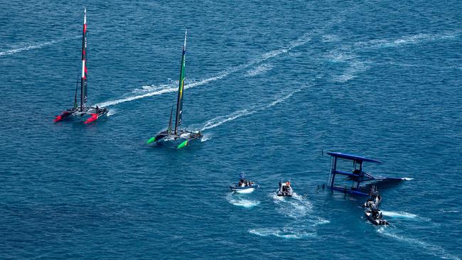 Support boats surround the capsized SailGP F50 catamaran of USA SailGP Team. Photo: Bob Martin for SailGP.