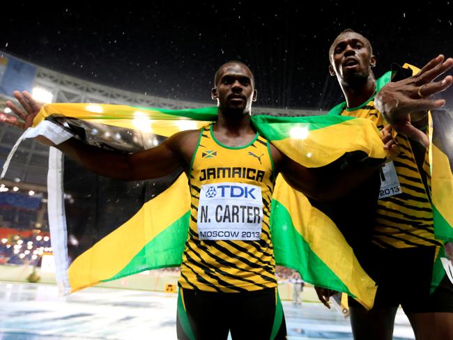 Usain Bolt of Jamaica poses with Nesta Carter in 2013.