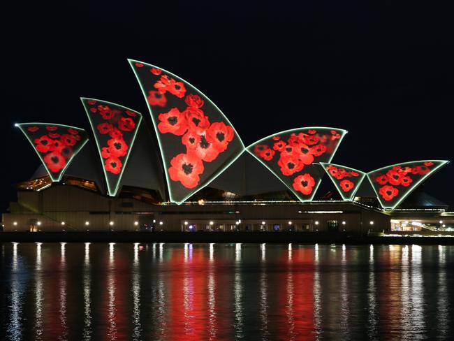 The Sydney Opera House was lit up with red poppies this morning as the city marked the beginning of Remembrance Day. Picture: NewsWire / Gaye Gerard