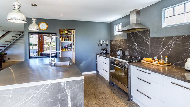The kitchen has stunning features, such as standout marble benchtops.