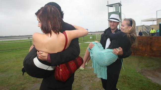Fred Baker carries friend Ebony Dignan and Dean McCluskey carries his wife Holly at the 2008 event. Picture: Nicholas Falconer