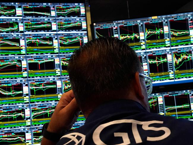 A trader works on the floor of the New York Stock Exchange (NYSE) in New York City on July 22, 2024. Wall Street stocks opened higher early Monday as tech shares bounced back after a recent pullback, as investors looked ahead to major earnings and economic data due this week. The US presidential race had produced a surprise over the weekend with Joe Biden bowing out of the race and throwing support to Vice President Kamala Harris. (Photo by TIMOTHY A. CLARY / AFP)