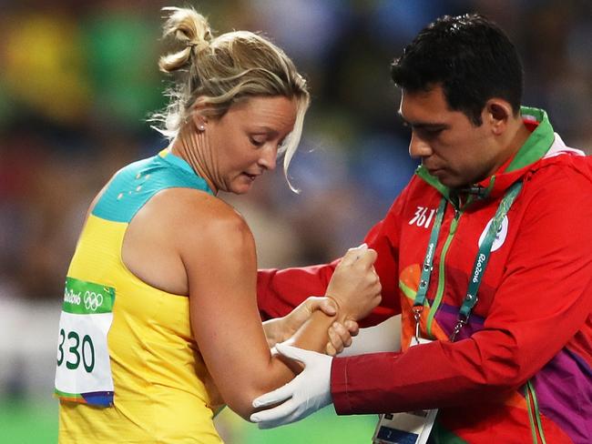 RIO DE JANEIRO, BRAZIL - AUGUST 16: Kim Mickle of Australia is assisted by medical staff after being injured during the Women's Javelin Throw Qualifying Round on Day 11 of the Rio 2016 Olympic Games at the Olympic Stadium on August 16, 2016 in Rio de Janeiro, Brazil. (Photo by Cameron Spencer/Getty Images)