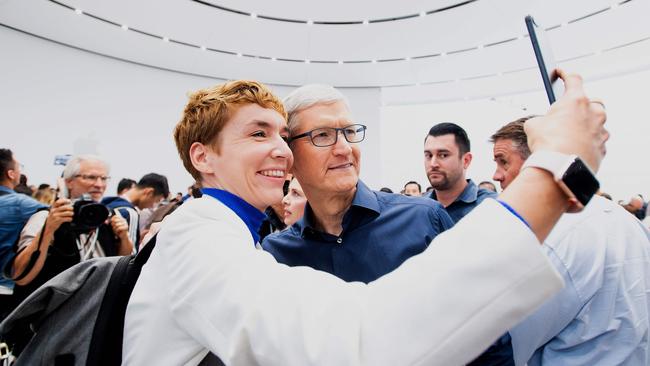 Apple CEO Tim Cook poses for a selfie with a journalist at a launch event. Picture: AFP
