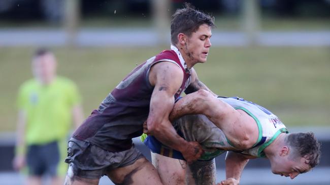 Moe’s Trent Baldi is tackled by Traralgon first-year player Liam Willaton.