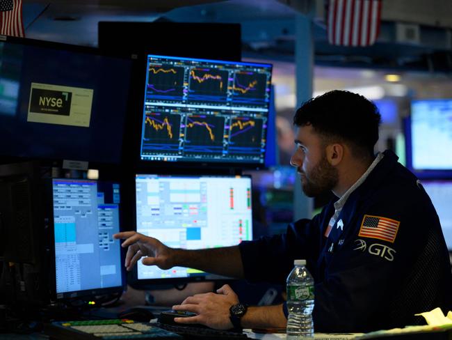 A trader works on the floor of the New York Stock Exchange (NYSE) at the opening bell on August 5, 2022 at Wall Street in New York City. - Stock markets slid Friday as a much stronger-than-expected US jobs report raised the prospect that the Federal Reserve will maintain its aggressive monetary policy to combat inflation. (Photo by ANGELA WEISS / AFP)