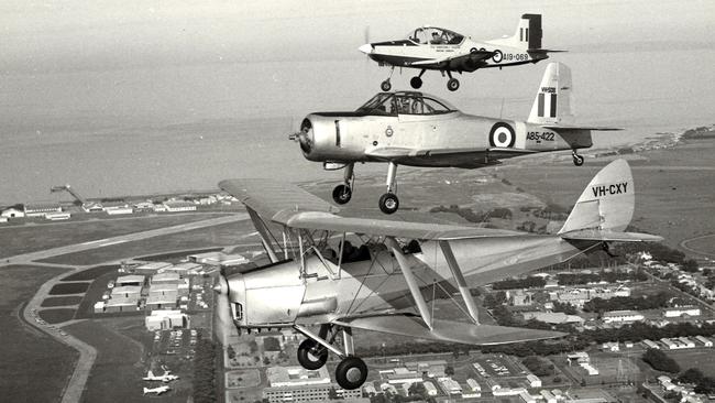 Three generations of training aircraft over RAAF base Point Cook in 1983, front to rear: Tiger Moth, Winjeel and CT4 planes.