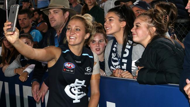 Jess Hosking of Carlton poses for a selfie with fans after a match in 2018. Picture: Hamish Blair